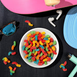 Trolli Mini Sour Brite Crawlers multi-flavored sour sugar coated candy assortment close up view.