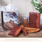 Lifestyle setting of the faith-inspired travel mug outdoors