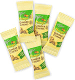 Individually wrapped mango flavored ginger candy pieces scattered outside the family size packaging.