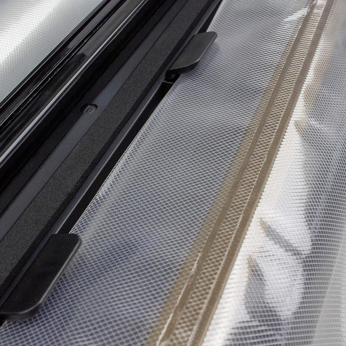Nesco vacuum sealer open lid showing built in roll storage and cutter