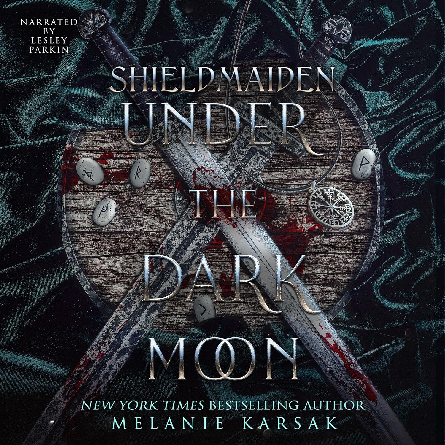 Melanie Karsak Shield-Maiden Under the Dark Moon audiobook cover featuring a runic Viking shield and crossed swords.