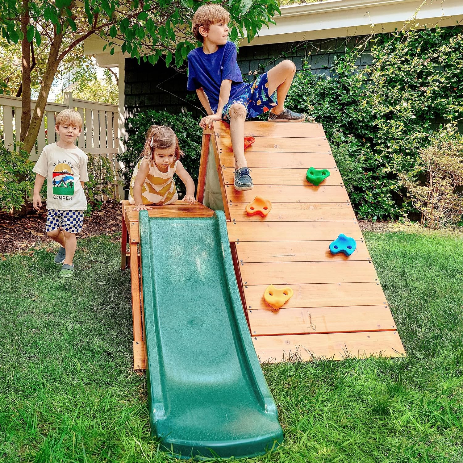 Avenlur Palm 5-in-1 wooden outdoor playground front view showing green slide and climbing ladder.