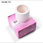 Self adhesive silk nail wrap roll pulling out from the top slit of the KADS box.