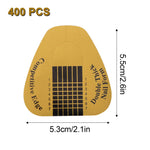 Close up of gold nail extension sticker with scale guide