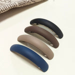 Trendy neutral tone fashion hair clips for long and textured hair.