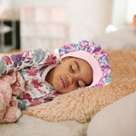 Close up view of the comfortable drawstring toggle on the toddler hair bonnet