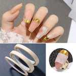 Applying beige nail art tape to manicured fingernails