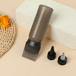 Ergonomic wide mouth root comb bottle being held to demonstrate the easy squeeze mechanism for mess-free hair coloring treatments.