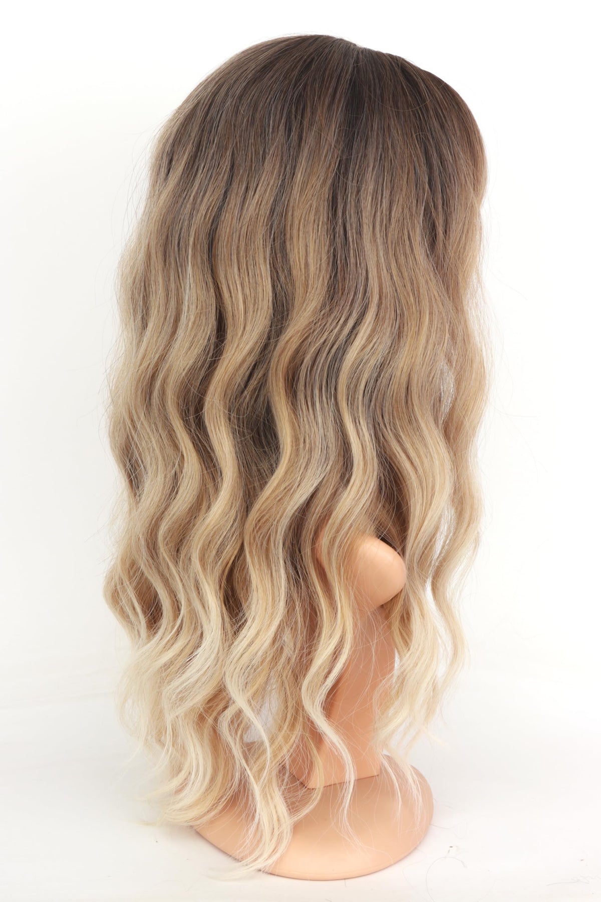 Side profile of the eighteen inch long ombre blonde wavy hairstyle for women