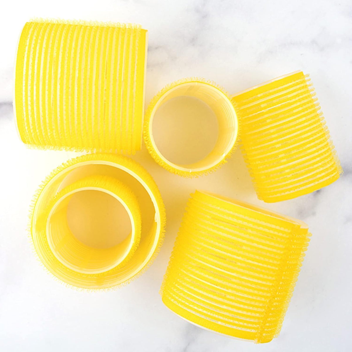 Close up view of the yellow self grip material on the Drybar hair rollers.