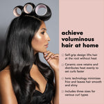 Three different sizes of the professional grade pink hair rollers arranged neatly on a surface