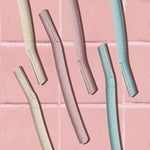 BULIMICA skincare tool being held at a forty five degree angle to illustrate proper facial shaving technique.