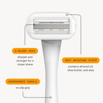 Minimalist white Nood reusable razor resting securely in its adhesive shower holder accessory mounted on a clean tile wall