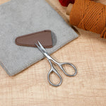Professional beauty mini scissors inside the open premium storage sheath