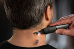 Micro Touch personal trimmer held in hand showing grip