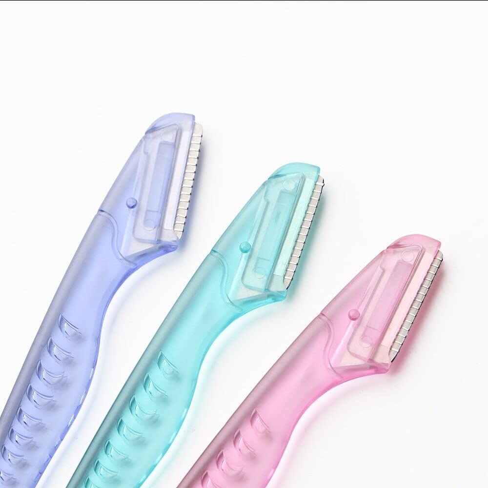 Pink facial hair remover tool with premium stainless steel blade close up