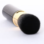 Authentic imported retractable cosmetic brush displayed open next to its protective cover