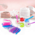 Compact and lightweight frosted plastic beauty spatulas held in hand to demonstrate the mini travel size