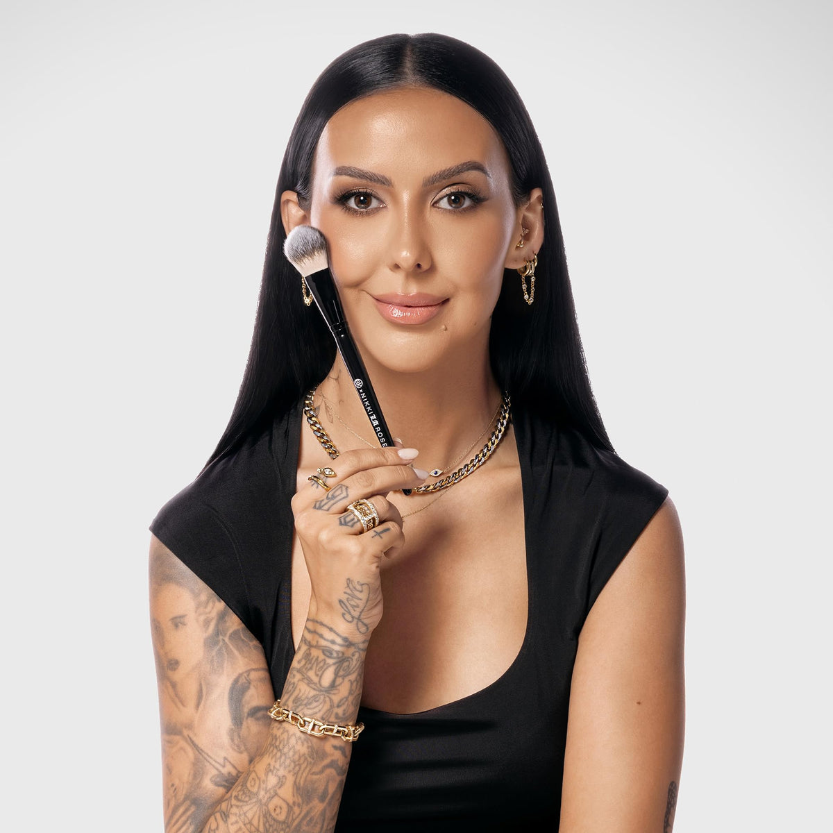 Nikki La Rose face brush blending liquid foundation on skin look