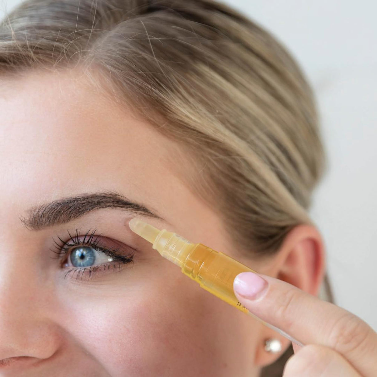 At home brow wax pen showing the slanted tip for mess free application