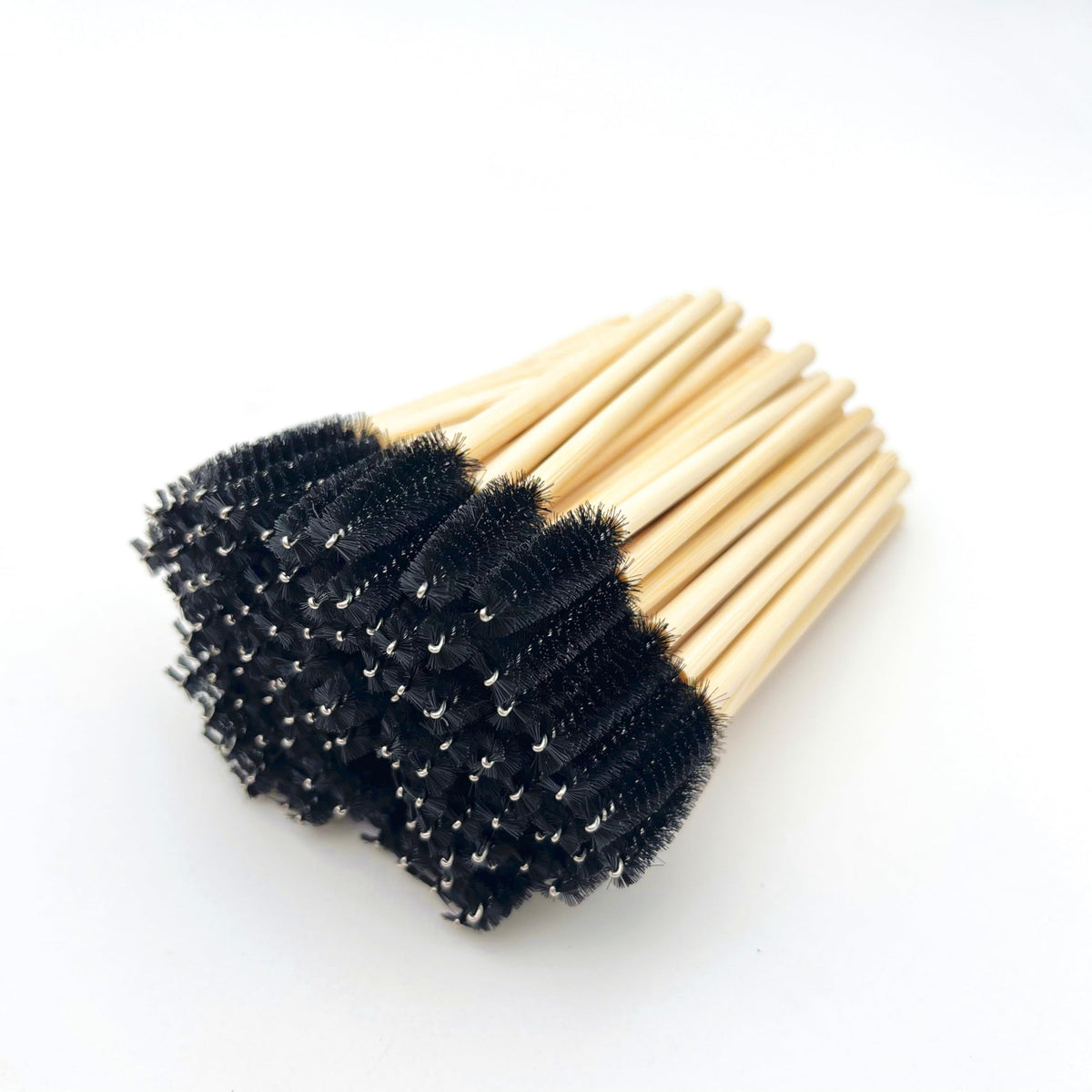 Close up of light green nylon bristle spoolies with bamboo handles
