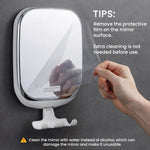 TAILI anti fog shaving mirror mounted on bathroom tile with a razor resting on the hook