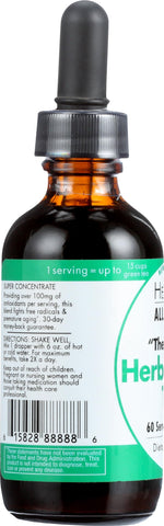Bottle of HerbaGreen Tea next to glass of water