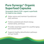 Pure Synergy Organic Greens Supplement vegan capsules being held for daily health routine visualization