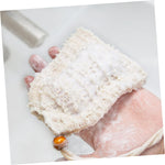Small soap scraps gathered inside the drawstring net bag to demonstrate zero waste feature.