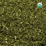 Brewed green herbal stinging nettle tea in a glass cup
