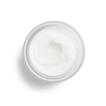 DHC skin renewing night cream placed on a clean vanity surface for nighttime routine