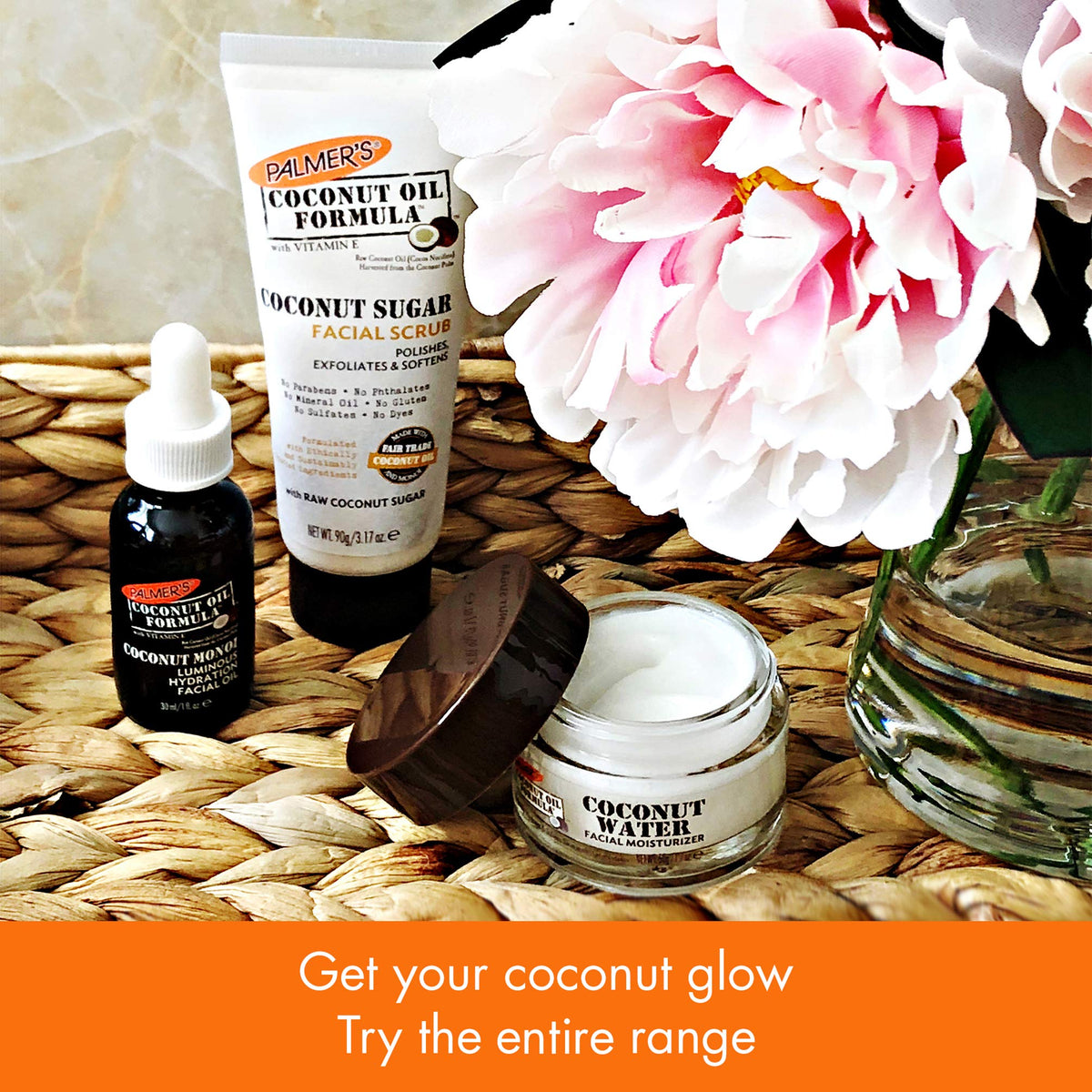 Palmer's exfoliating facial scrub tube with chamomile placed next to natural coconut elements