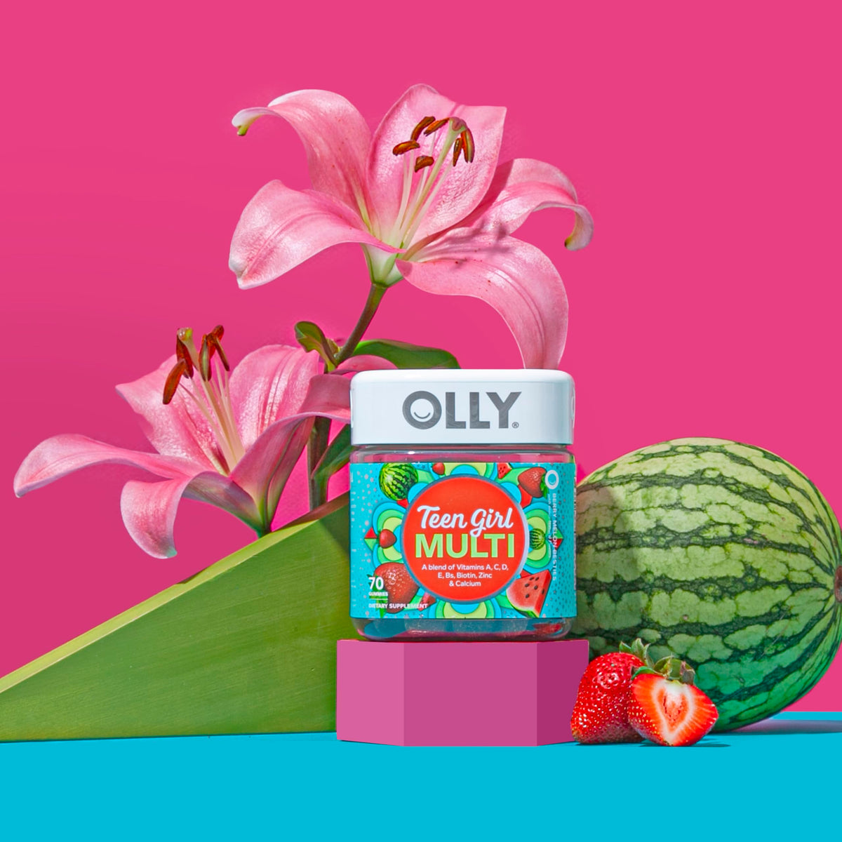 Close up of OLLY premium pectin based teen multivitamin gummies in strawberry melon shade.