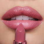 Charlotte Tilbury Icon Baby shimmering nude-rose moisturizing lipstick for full looking lips.