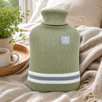 Soft gray striped hot water pack placed on feet providing cozy warmth during cold nights.