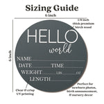Six inch wooden hello world newborn arrival board held as a hospital photo prop.