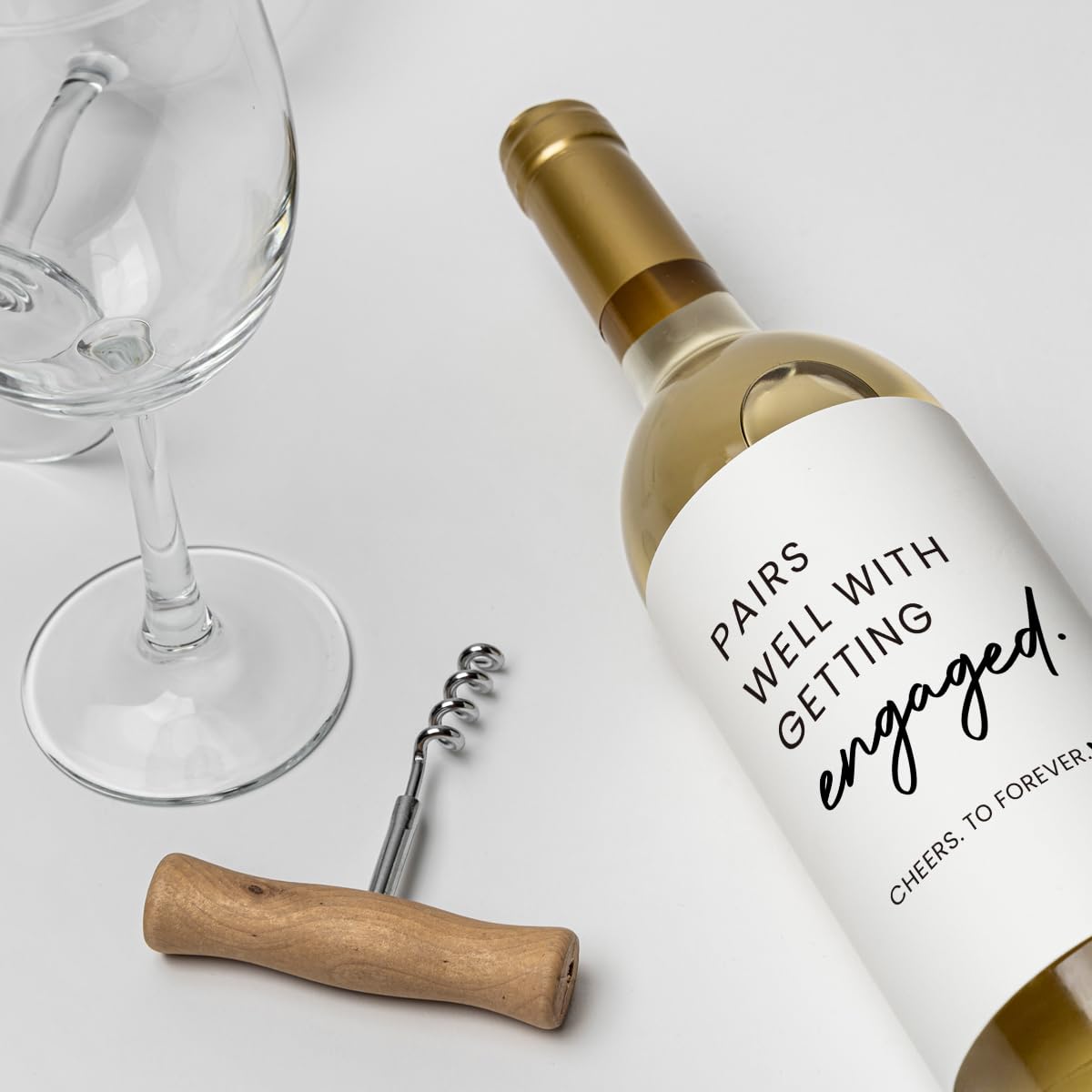 Water resistant vinyl engagement bottle labels resting in an ice bucket during a celebration.