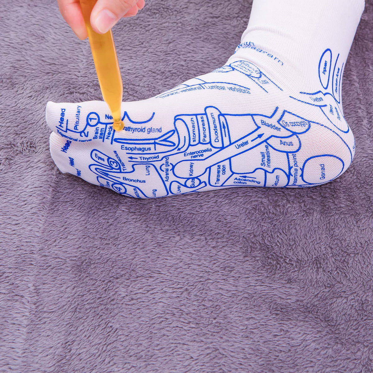 Woman wearing reflexology socks with massage tool