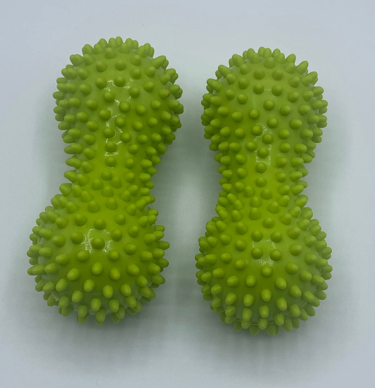 Person using green spiky peanut balls for foot reflexology and plantar fasciitis