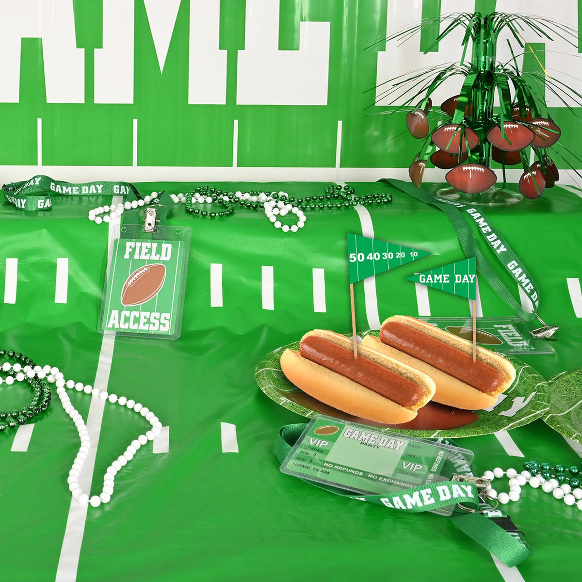 A pack of one hundred USA-imported Beistle football food toothpicks arranged neatly next to cupcakes.
