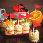 Mozeat Lens small red stick flags inserted into party appetizers demonstrating real life scale and food presentation.