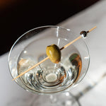 Eco friendly bamboo cocktail picks with reflective silver tops spread out cleanly.