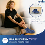 Person relaxing at home wearing navy Revix foot warmers