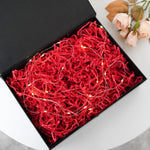 Close up of vibrant red shredded paper for gift packaging