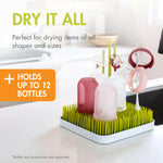 Boon Grass drying rack holding various baby feeding accessories