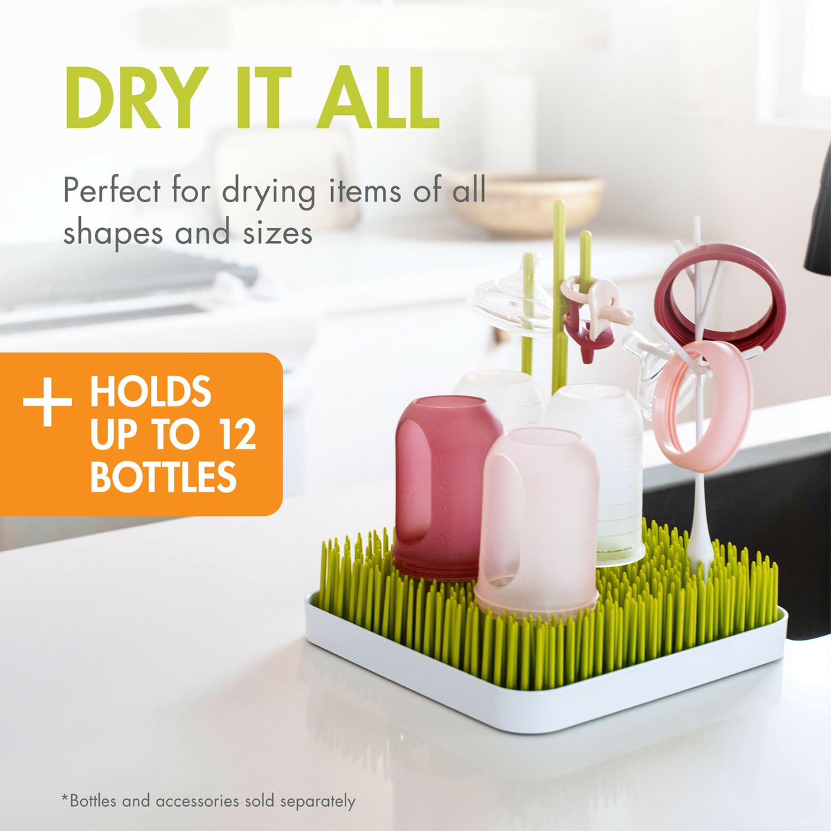 Boon Grass drying rack holding various baby feeding accessories