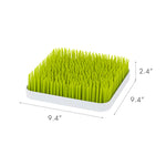 Close up of flexible green grass blades for bottle drying