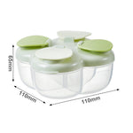 Green multi compartment formula dispenser next to an infant feeding bottle.