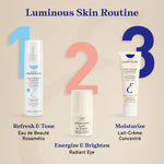 Embryolisse Lait-Crème Concentré sitting vertically on a vanity counter next to luxury beauty essentials