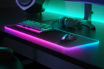 Angled view showcasing the vivid two zone customizable illumination edges of the SteelSeries desktop mouse pad.